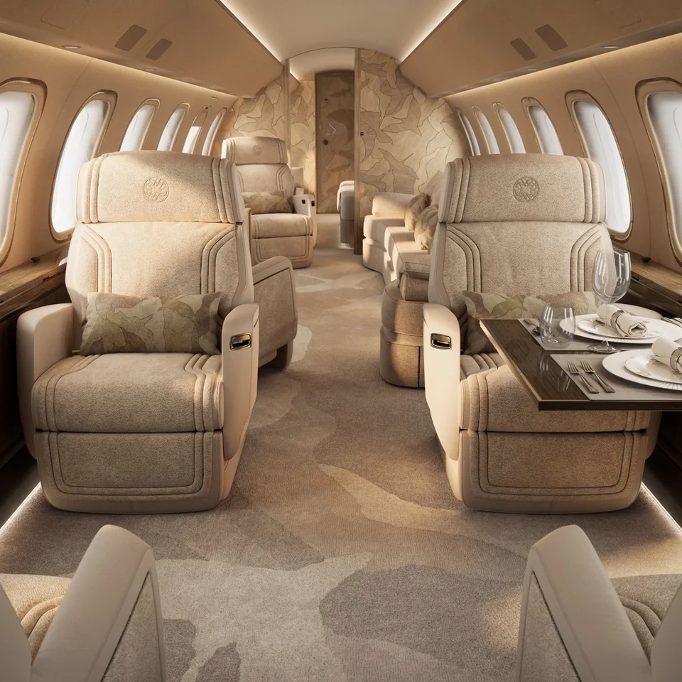 Elegant private jet cabin with warm beige seating and a dining table